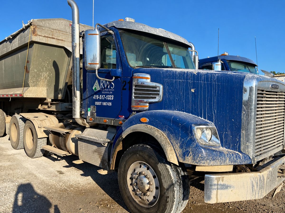 Blue tractor numbered 21 covered in dried mud and drip streaks on the hood and fender.