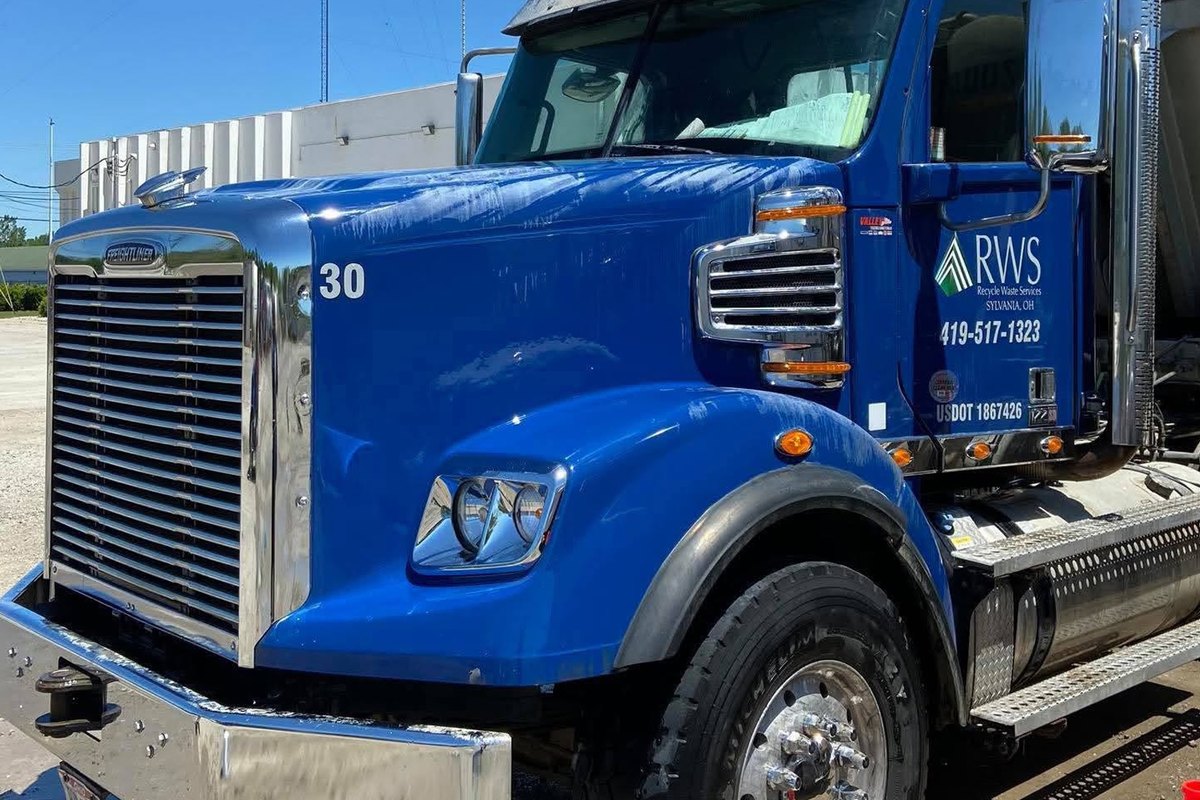 Blue truck numbered 30 with clean glossy blue paint and a shining chrome bumper and wheel under a bright blue sky.