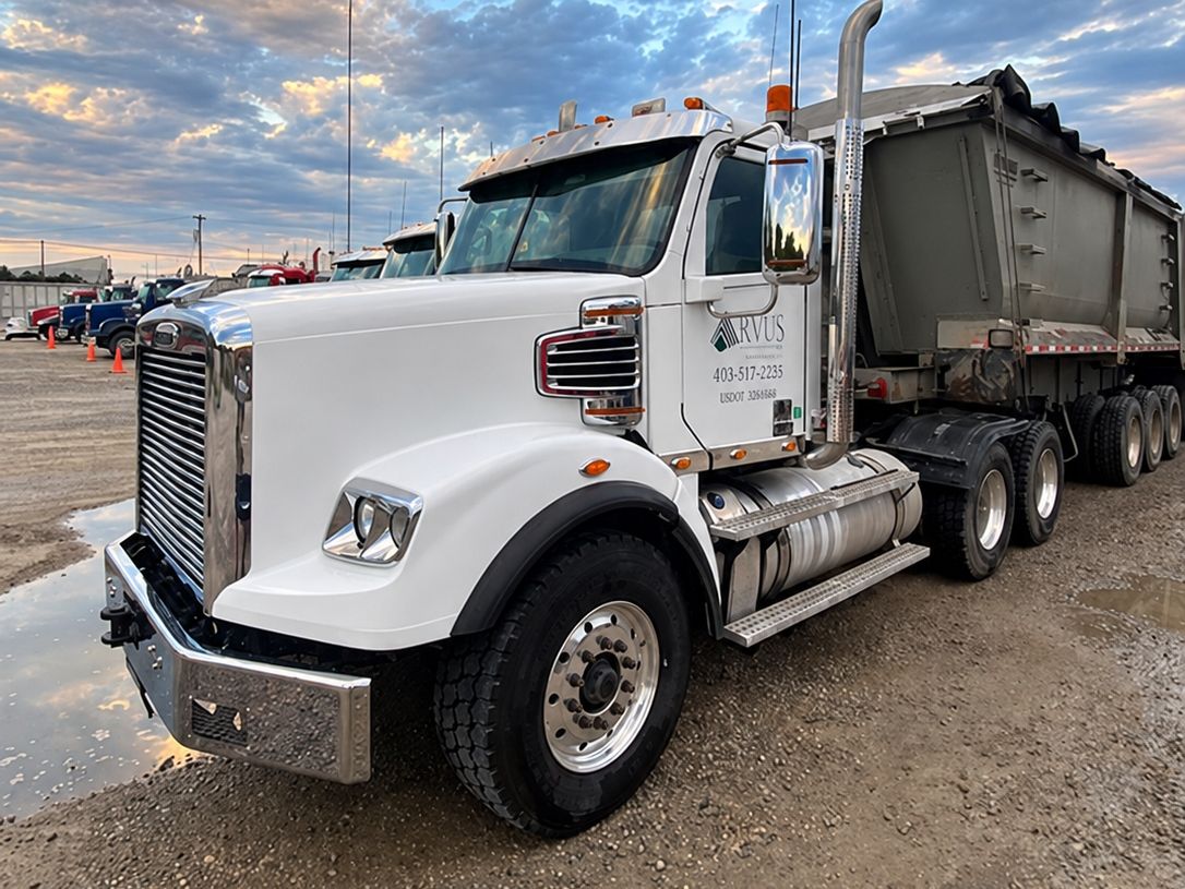 White dump-truck tractor, now clean, with a polished wheel and chrome bumper.